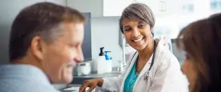 A doctor smiles at a patient